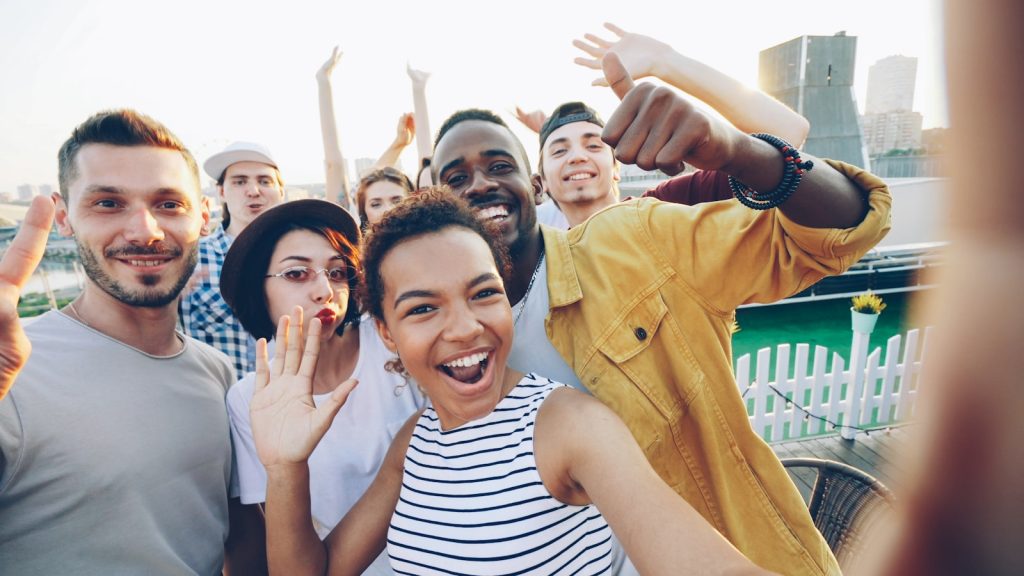Diverse group of friends taking a selfie outdoors selfie