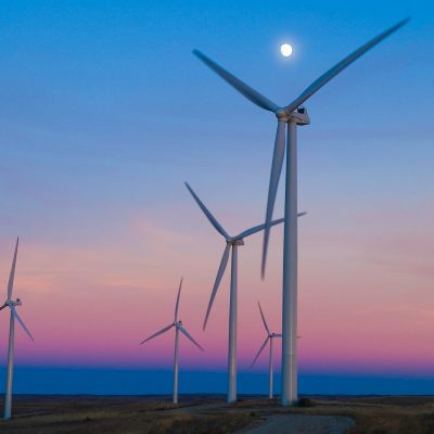 five windmills in front of ocean